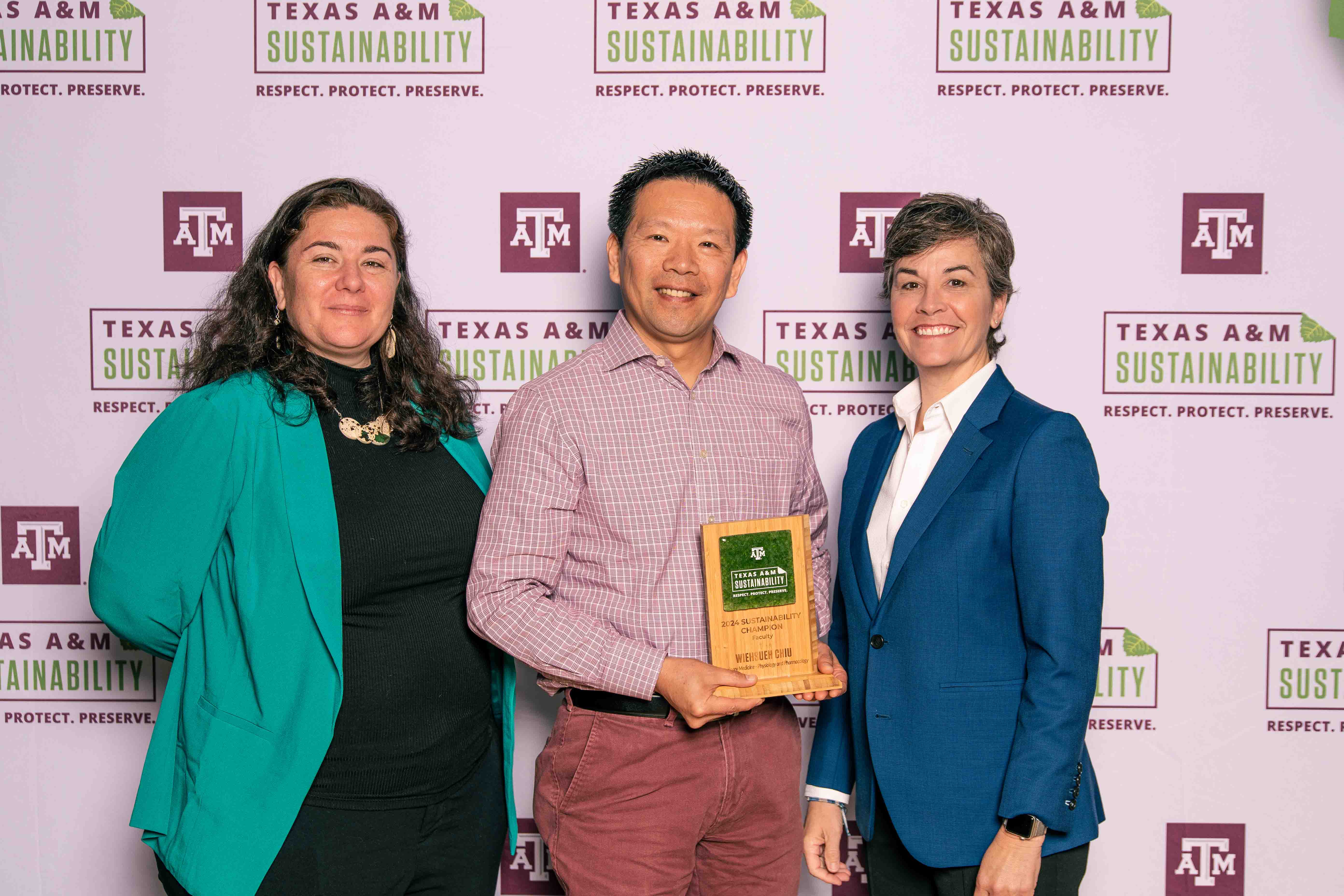 Dr. Weihsueh Chiu accepting the Sustainability Champion Staff Award with Kelly Wellman and Ben Kalscheur